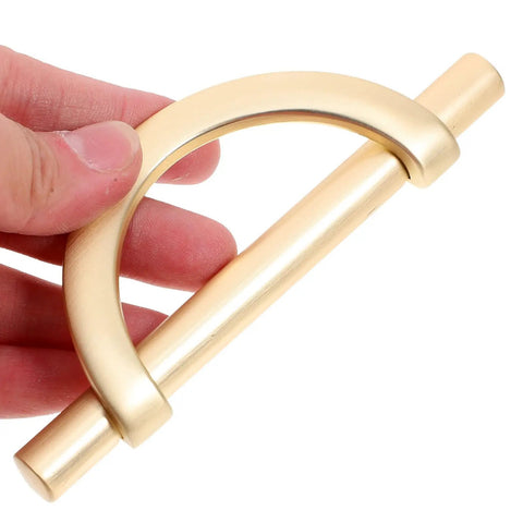 Close-up of a Six Piece Zinc Alloy Half Round Cabinet Pull with Gold Brushed Finish, showing design and smooth texture.