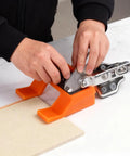 Magnetic Cabinet Door Hinge Spacer With Scale For A Clean 2mm Gap Handy Hinge Alignment Tool For Cabinet Door Installations Magnetic Hinge Jig To Nail The Door Gap 2 Pack In Bright Orange being used to align a cabinet door hinge.