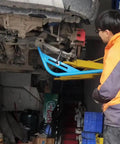 Mechanic using Wishbone Extractor Tool For Car Suspension, Lower Control Arm Lever Bar With Steel Tube And Hook on vehicle