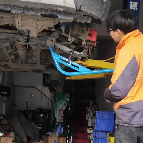 Mechanic using Wishbone Extractor Tool For Car Suspension, Lower Control Arm Lever Bar With Steel Tube And Hook on vehicle