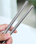 Person holding 2 Durable 10mm 304 Stainless Steel Round Rods 12 Inch 305mm Solid Metal Rods for DIY Crafts Metalworking and Industrial Projects Corrosion Resistant 2 Pack.