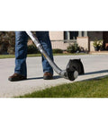 Lightweight Cordless String Trimmer And Edger With Slick Rotating Shaft For No Sweat Yard Work Compatible With 18 Volt Lithium Batteries Tool Only in use on grass.