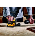 Person using Cordless Quarter Sheet Sander Kit With Brushless Motor Variable Speed 8000 To 14000 OPM 20V Max XR 2.0Ah Battery