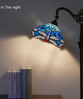 Tiffany Style Stained Glass Floor Lamp 62 Inch Tall With Blue Dragonfly Shade, soft ambient light, arched arm in living room at night.