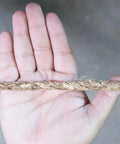 Three Eighths Inch Natural Fiber Manila Rope, Three Strand Tan Rope Roll shown in hand for scale
