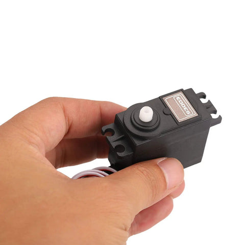 Ultra Quiet RC Servo Compatible With Futaba Systems in hand, showcasing black polymer casing and connector wires.