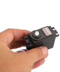 Standard RC Servo For Rc Cars Quick Response Low Noise Steering Motor held in hand, compact and lightweight design, perfect for upgrades.