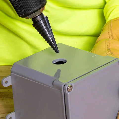 Step Drill Bit 14 Double Fluted 3/16 to 7/8 Inch with Easy Read Step Markings and Targets in use on metal sheet