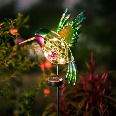 Outdoor Solar Hummingbird Garden Lights For Pathway And Patio, cozy warm yellow LED stake lights glowing in a garden