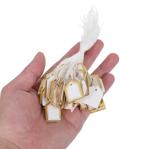 500 Pack Small Fan Shaped Price Tags With String For Clothing Jewelry Vendors Paper Tags With Writable Surface Great For Booths Crafting Stock Labels Gift Tags And Small Business Use For Your Shop, hand holding white and gold paper tags