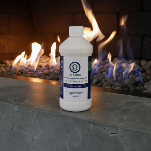 Concrete Countertop Sealer For DIY Kitchens And Surfaces, Food Safe Water Based Non Toxic Finish With Satin Sheen, 16 Oz bottle on concrete ledge with fire background