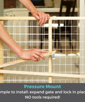Extra Wide Wooden Baby Gate With Wire Mesh Pressure Mounted Gate being adjusted to fit doorway for kiddo safe use