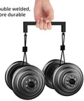 Hand holding double-welded weights with durable black handle, illustrating strength and sturdy construction.