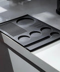 No Fuss Pvc Espresso Tamping Mat And Bar Drip Tray For Straight Up Counter Guard With Stick Tight Non Slip Coffee Distribution Pad Easy Clean Black Single Piece on countertop.