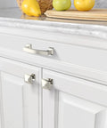 Modern kitchen drawers with silver handles, contrasting with white cabinetry.
