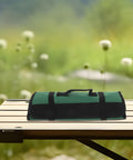 Green Multi Functional Chef Knife Roll Bag With Pockets And Handle For Kitchen And Outdoor Camping on a wooden table