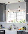 Antique Style Adjustable Glass Pendant Light Fixture With Brass Hardware For Kitchen Island And Dining Room, shown in kitchen