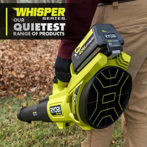 Bad Boy Cordless Leaf Blower Featuring A Smooth Brushless Motor That Runs Quiet While Cranking Out 160 MPH Winds For Tough Yard Work No Sweat Guaranteed Easy Setup Every Time Tool Only held by a person with fallen leaves in background.