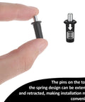 Close-up of hand holding a spring pin from the 8 Piece Cabinet Door Repair Pins Set For Damper Replacement And Furniture Fittings.