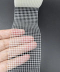 Fiberglass Drywall Repair Tape Self Adhesive Mesh, 2 Inch by 100 Ft Roll, shown unwinding with visible mesh texture.