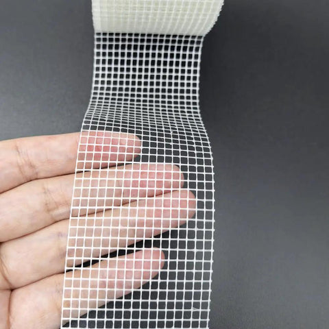 Fiberglass Drywall Repair Tape Self Adhesive Mesh, 2 Inch by 100 Ft Roll, shown unwinding with visible mesh texture.