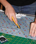 Person using 45mm Rotary Cutter Blades Pack Of 10 For DIY Quilting Sewing And Crafts on star-patterned fabric