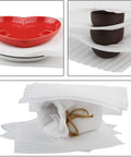 Heart-shaped and round dishes wrapped in 12x12 Foam Wrap Sheets For Packing And Moving Supplies, Cushion Foam Sheets For Dishes And Glassware, 50-Pack Pre-Cut Recyclable Polyethylene Padding For Fragile China And Chinaware, Ideal For Storage And Shipping With Killer Scratch-Free Protection.