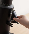 Close-up of the Dope Single Dose Electric Coffee Grinder Featuring 64Mm Titanium Flat Burrs and Stepless Adjustment in black finish.