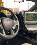 Heavy Duty Laptop Docking Station Featuring Advanced Port Replication Dead Simple Setup And Secure Quick Release Lock Built Like A Tank For Hard Core Field Crews installed in a vehicle.