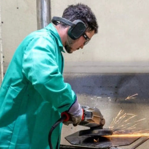 Worker using grinder while wearing Behind-The-Head Ear Muffs With 25dB NRR Hearing Protection For Construction
