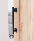 Antique Rustic Twelve And Five Eighths Inch Barn Door Handle on wood door, frosted black finish, square base