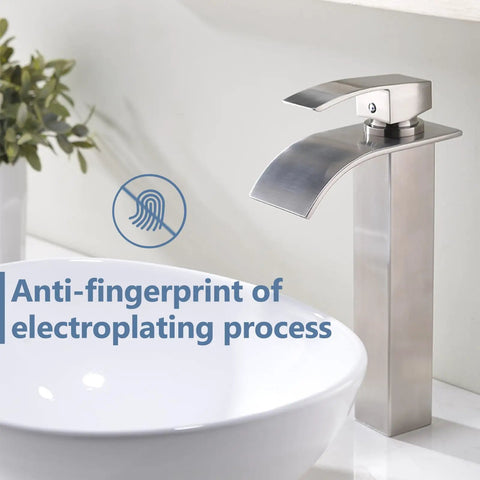 Wide Waterfall Spout Vessel Sink Faucet In Brushed Nickel Tall Above Counter Single Handle Vanity Lavatory Faucet shown beside white basin