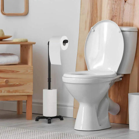 Beefy Industrial Black Free Standing Toilet Paper Holder Dispenser for Bathroom next to white toilet