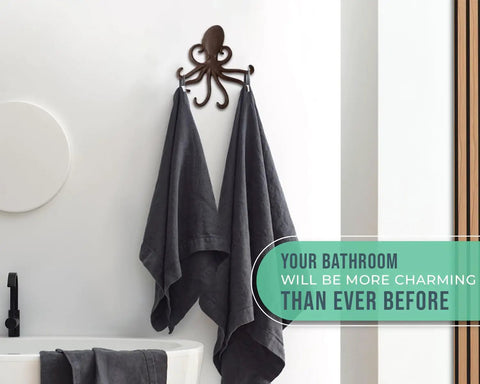 Rad Cast Iron Octopus Wall Hook Rustic Brown Antique Finish with towels hanging, adding nautical decor to a bathroom.