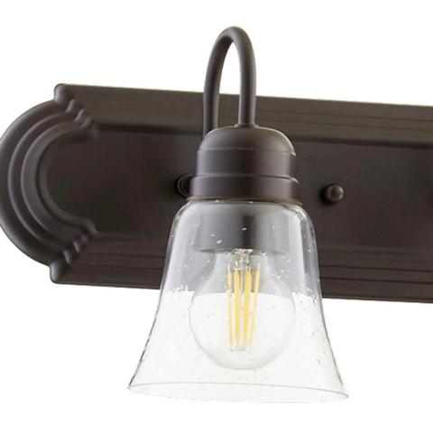 Close-up of a light on Transitional Five Light Vanity Fixture in Oiled Bronze with Clear and Seeded Glass Damp Rated Bathroom Lighting 36 Inch