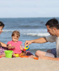 Family playing with Epic 19-Piece Beach Sand Toy Set For Kids Ages 3 To 13, including bucket and watering can, on the beach