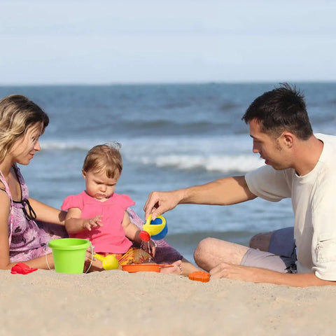 Family playing with Epic 19-Piece Beach Sand Toy Set For Kids Ages 3 To 13, including bucket and watering can, on the beach