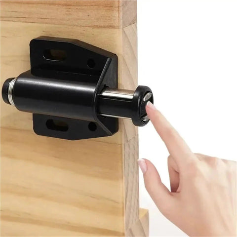 Hand demonstrating 16 Pieces Magnetic Push To Open Cabinet Latches for easy wardrobe doors, strong rebound magnet installed on wood