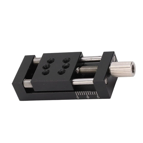 Knockout Heavy Duty Manual Linear Actuator Stage Featuring Smooth Glide Aluminum Dovetail Slide Platform And Dead Set Micro Tuning Adjustments For Real World Job Sites detailed view of black linear actuator with adjustment knobs.