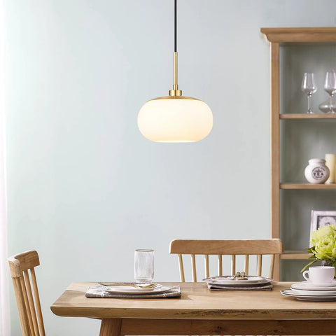 Single Opal Glass Pendant Light With Antique Brass Finish for a Cozy Modern Vibe in dining area.