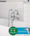 Polished Chrome Clawfoot Tub Faucet With Wall Mount and Handheld Shower, Double-Handle Tub and Shower Mixer installed on tile wall.