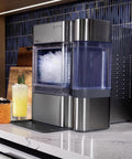 Front view of GE Profile Opal 2.0 nugget ice maker, stainless steel with clear ice bin and side water tank.