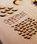 Close-up of wood carving showing scales and eye details created using Concave Eye Cutter Set for precise texture work.