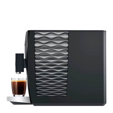 Top Shelf Automatic Coffee Machine In Sleek Piano Black Featuring Fresh Aroma Grinder PEP Brew Tech Dual Cup Options And Killer Crema side view with espresso cup.