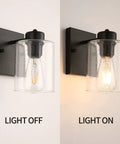 Set Of Two Matte Black Wall Sconces With Clear Glass Shade, Industrial Farmhouse Vanity Lighting Fixtures For Bathroom Mirror And Hallway, Bulbs Not Included, showing light off and light on.