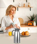 Kitchen counter with Double Walled Stainless Steel Thermal Coffee Carafe 68-Ounce Two-Liter Capacity Dispenser for Hot And Cold Bevs.