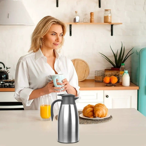 Kitchen counter with Double Walled Stainless Steel Thermal Coffee Carafe 68-Ounce Two-Liter Capacity Dispenser for Hot And Cold Bevs.
