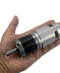 Hand holding 12V 24V DC Low Speed Long Life 42mm Planetary Gearbox Motor Brushed Gearmotor, showcasing compact and durable design.