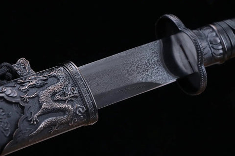 Close-up of a Beefy Damascus Tang Dao Sword with Black Gold Finish, showing the intricate alloy fittings and traditional folding pattern.