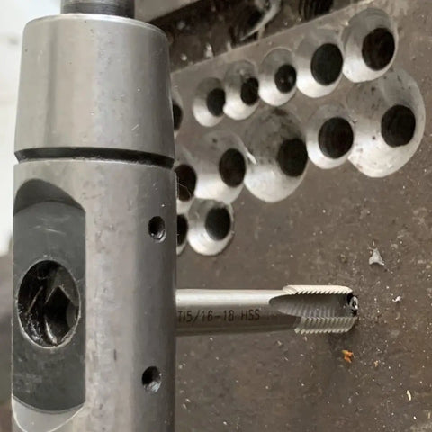 Close-up of M5 X 0.8 Helical STI Thread Repair Kit in use, showing tap tool and inserts for repairing damaged holes in metal